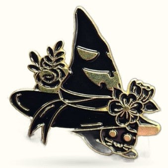 Black enamel witch hat pin badge with gold trim, flowers, and mystical moon details