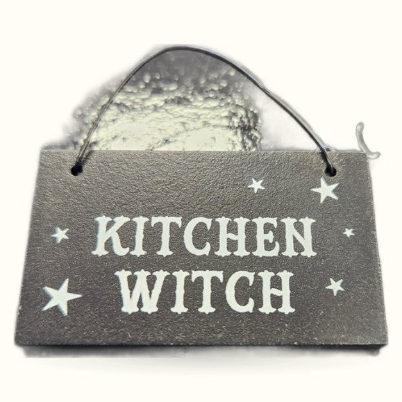 Grey wooden Kitchen Witch sign with white text and stars, displayed with rope handle against white background