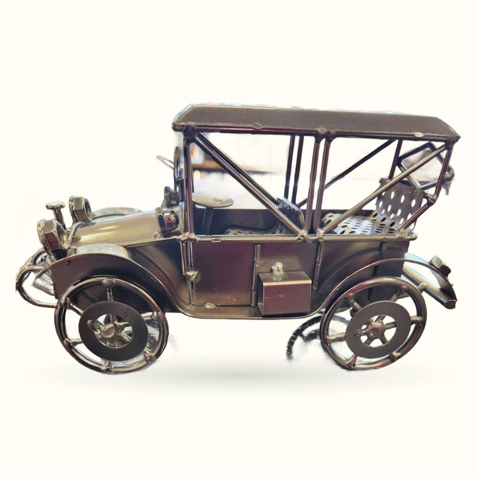 Vintage brass and copper motorcar model with retractable canopy top and detailed wheels