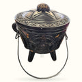 Black cauldron with triple moon and pentagram design, ornate lid, metal handles and tripod legs