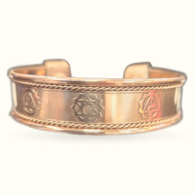 Rose gold copper cuff bracelet with rope edge detailing and chakra symbol engravings