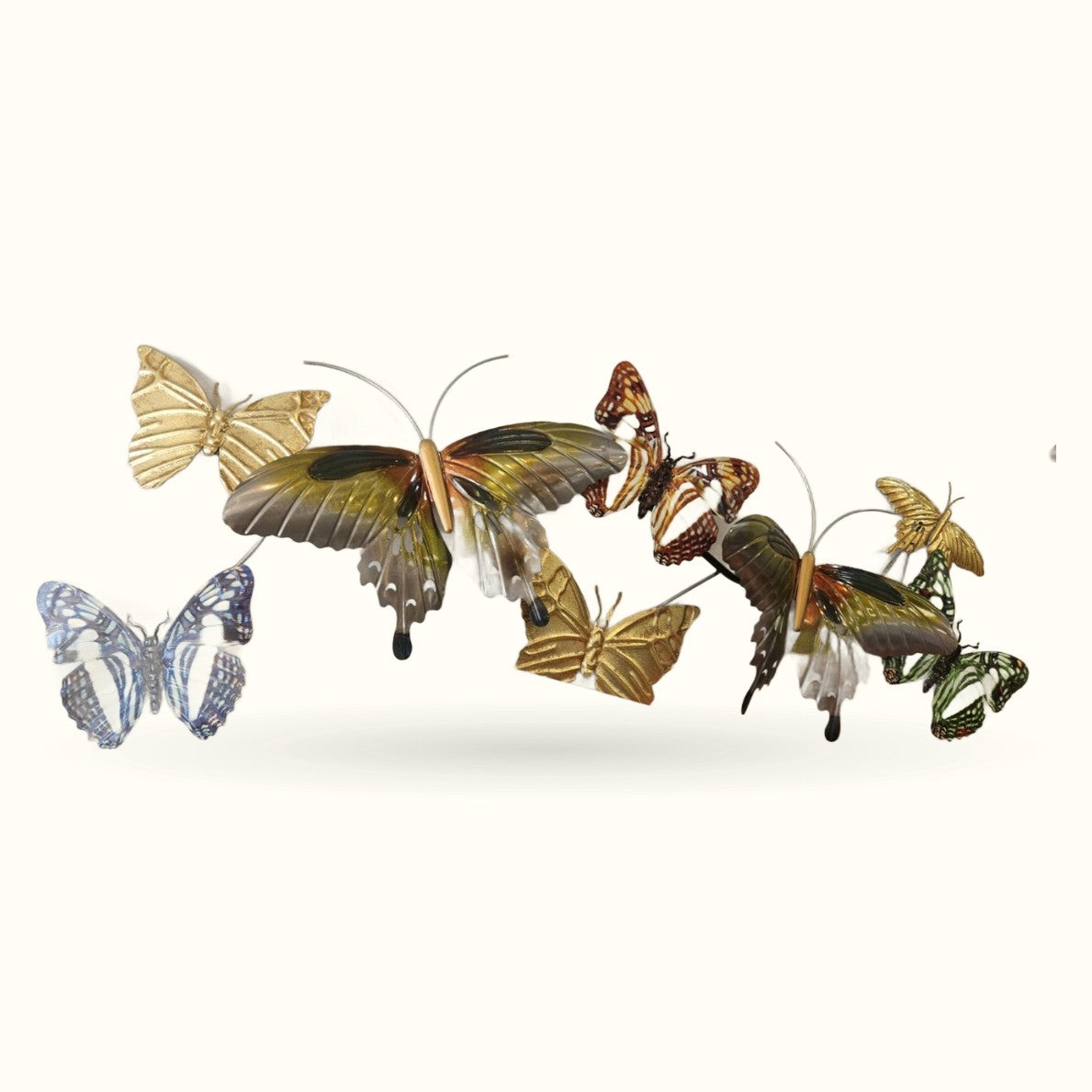 Decorative butterfly wall hangers in gold, brown, and blue metallic finishes arranged in a group