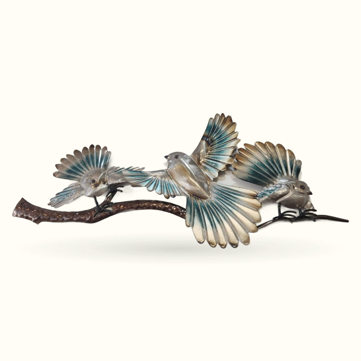 Three decorative blue fantail birds perched on a textured bronze branch