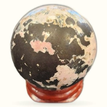 Decorative globe with world map on red stand, not a rhodochrosite crystal sphere
