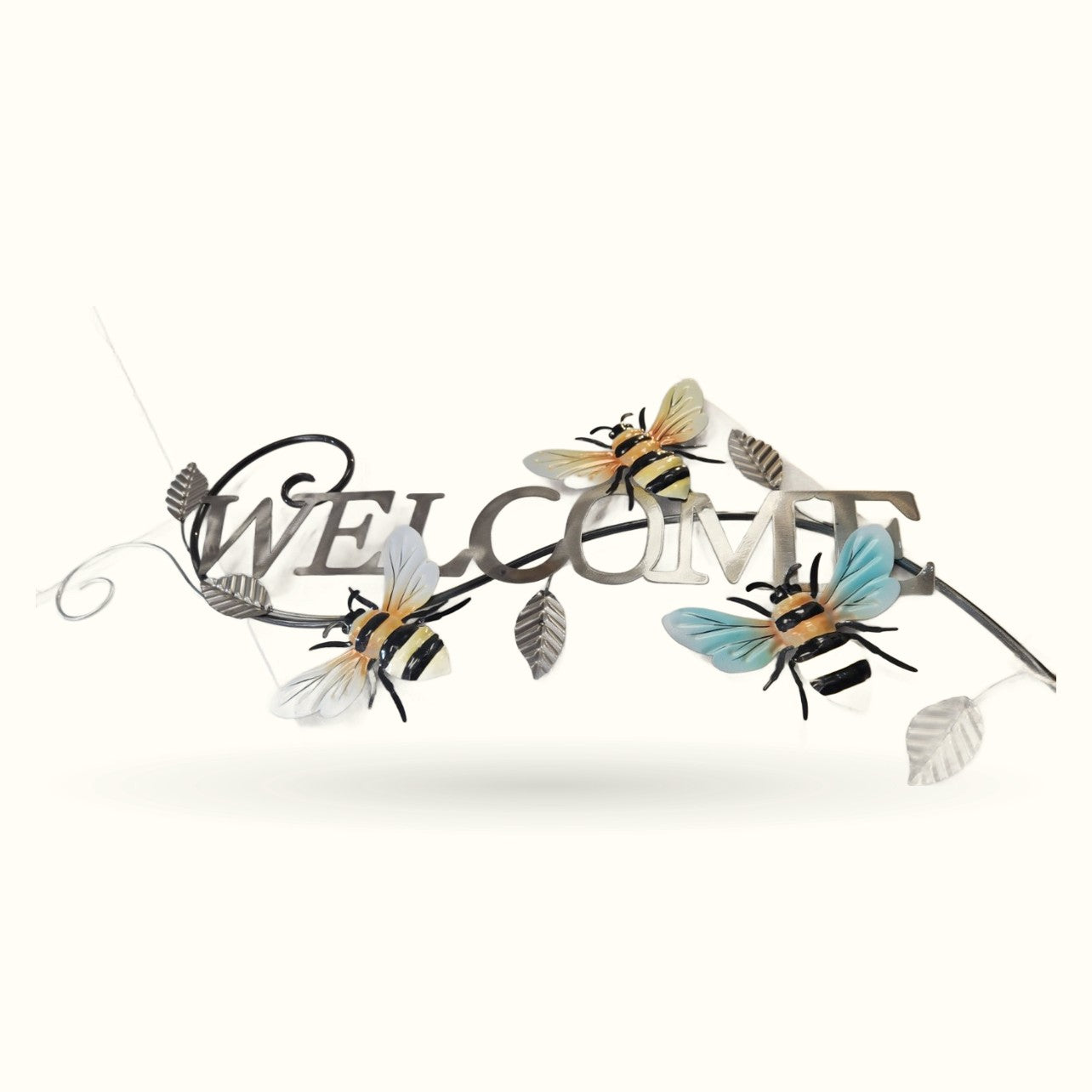 Welcome tin sign with decorative metal text and three colorful bees with yellow, white, and blue wings