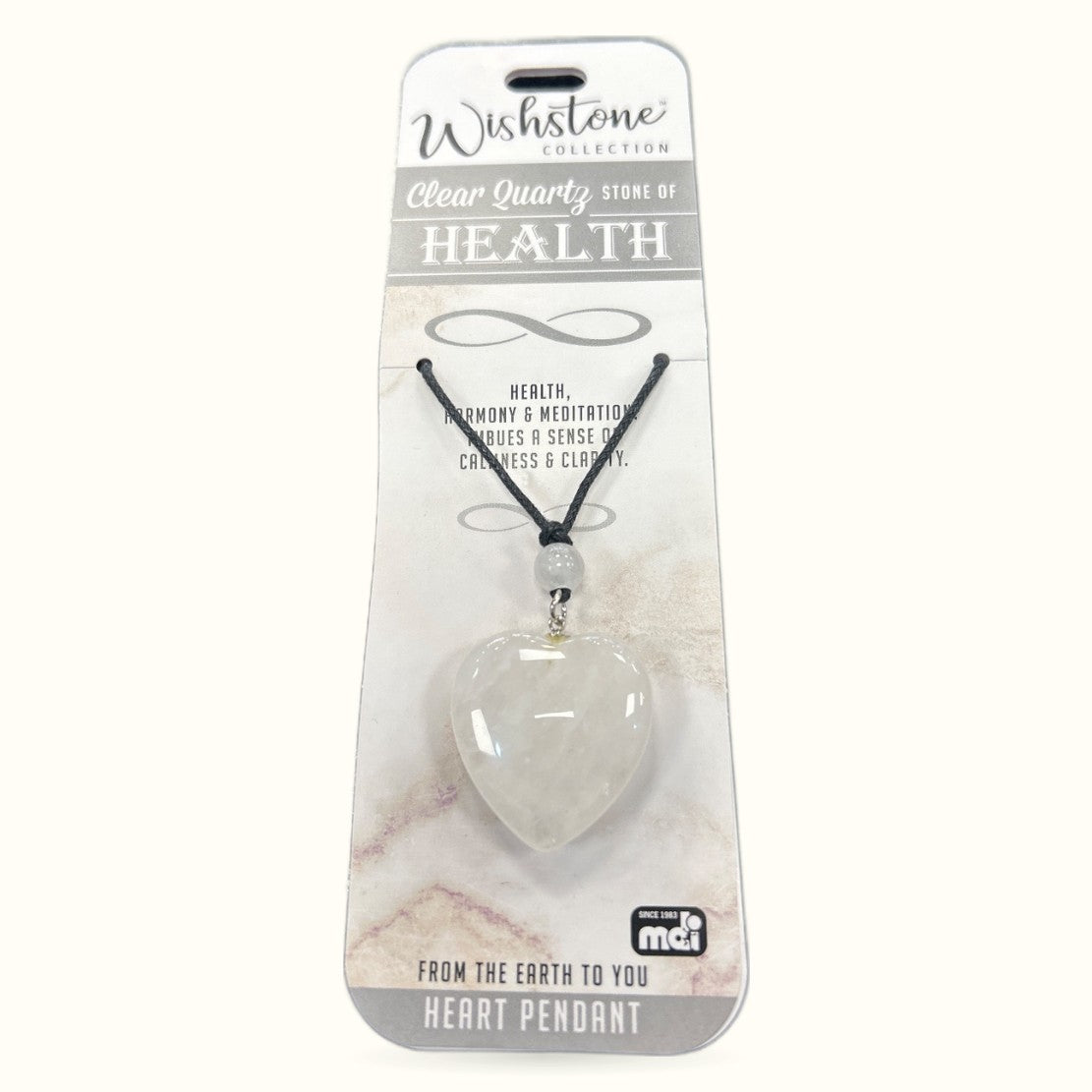 Clear quartz heart pendant on black cord from Wishstone Collection, displayed on branded packaging