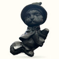 Black obsidian carved witch cat wearing a hat and sitting on a broomstick