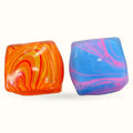 Two tie-dyed squishy squares - one orange with red swirls, one blue with pink and purple swirls