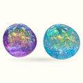 Two glitter squishy balls - one purple with gold sparkles, one turquoise with rainbow iridescent glitter