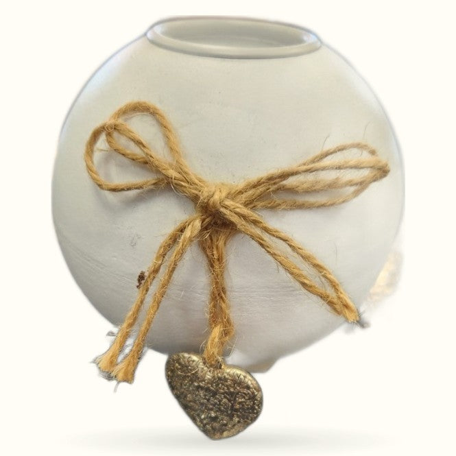 Round white ceramic candle holder with twine bow and bronze heart charm pendant