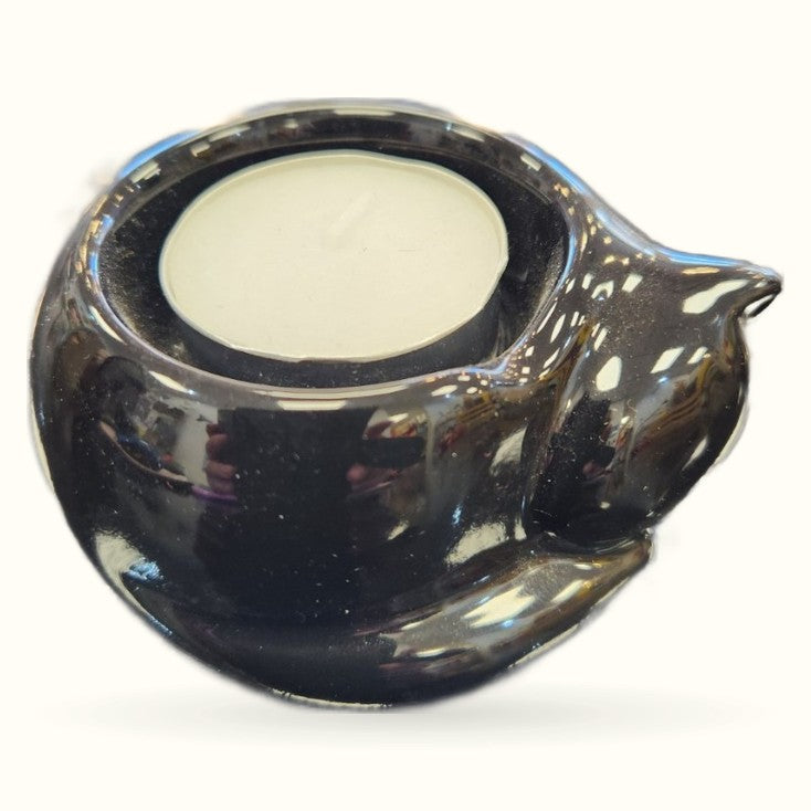 Black ceramic cat-shaped tealight holder with glossy finish and cream-colored interior