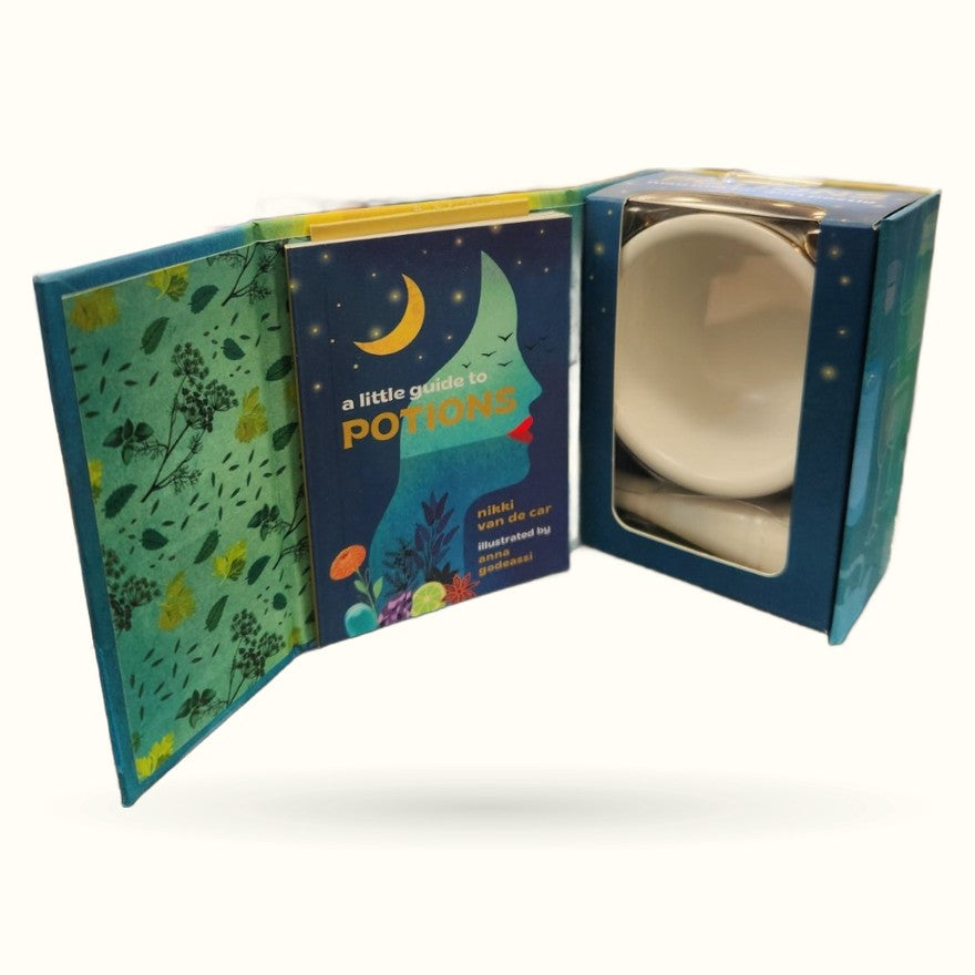 A little guide to potions gift set with ceramic mortar and pestle in cream, displayed with illustrated blue and green packaging