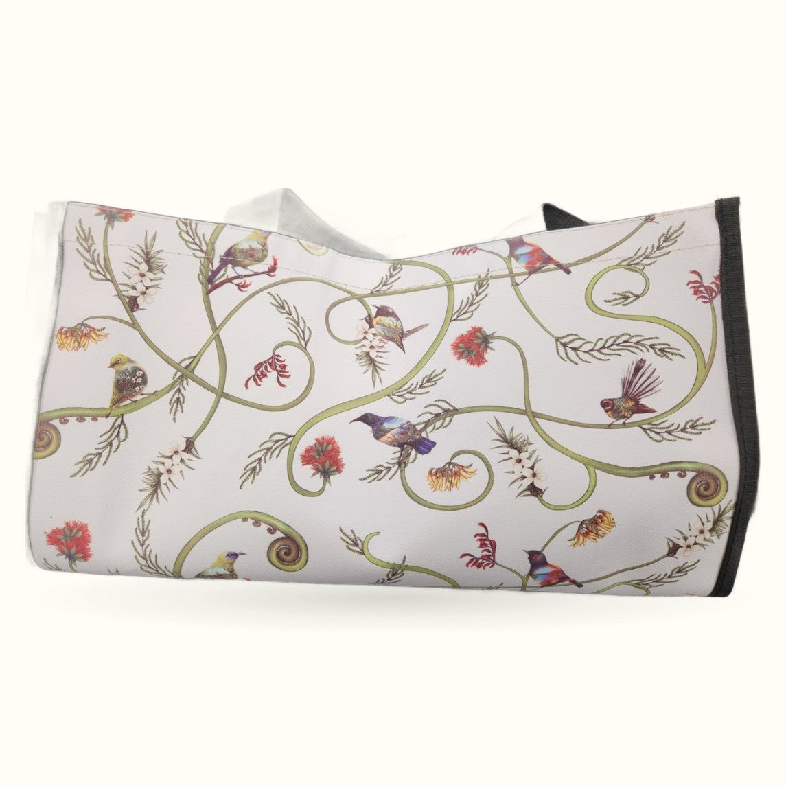 Cream tote bag with decorative vine scrolls, native birds, and red flowers in botanical pattern