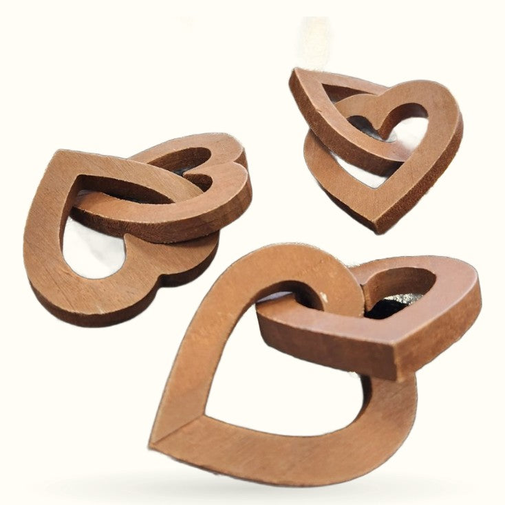 Three wooden double heart decorations in natural brown wood tones, artfully arranged
