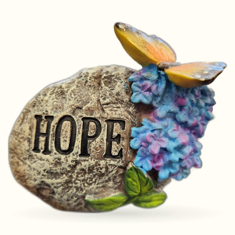 Stone Hope Rock garden ornament with colorful blue and pink hydrangea flowers and golden butterfly