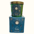 White Sage The Sun tarot candle in green glass jar with gold lid, displayed with matching blue box packaging