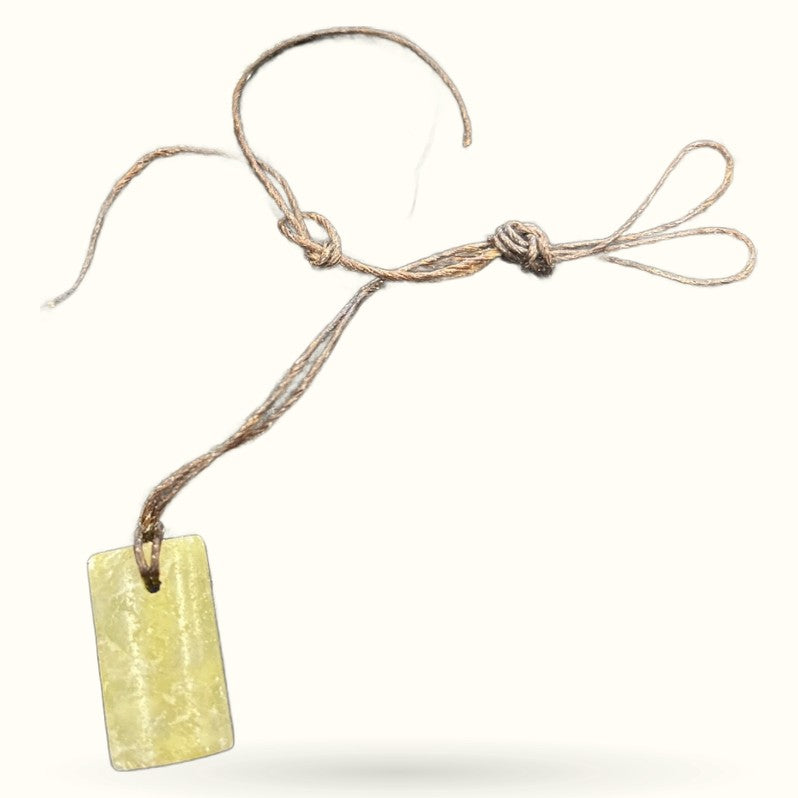 Square pale green greenstone pendant on natural twine cord with adjustable knots