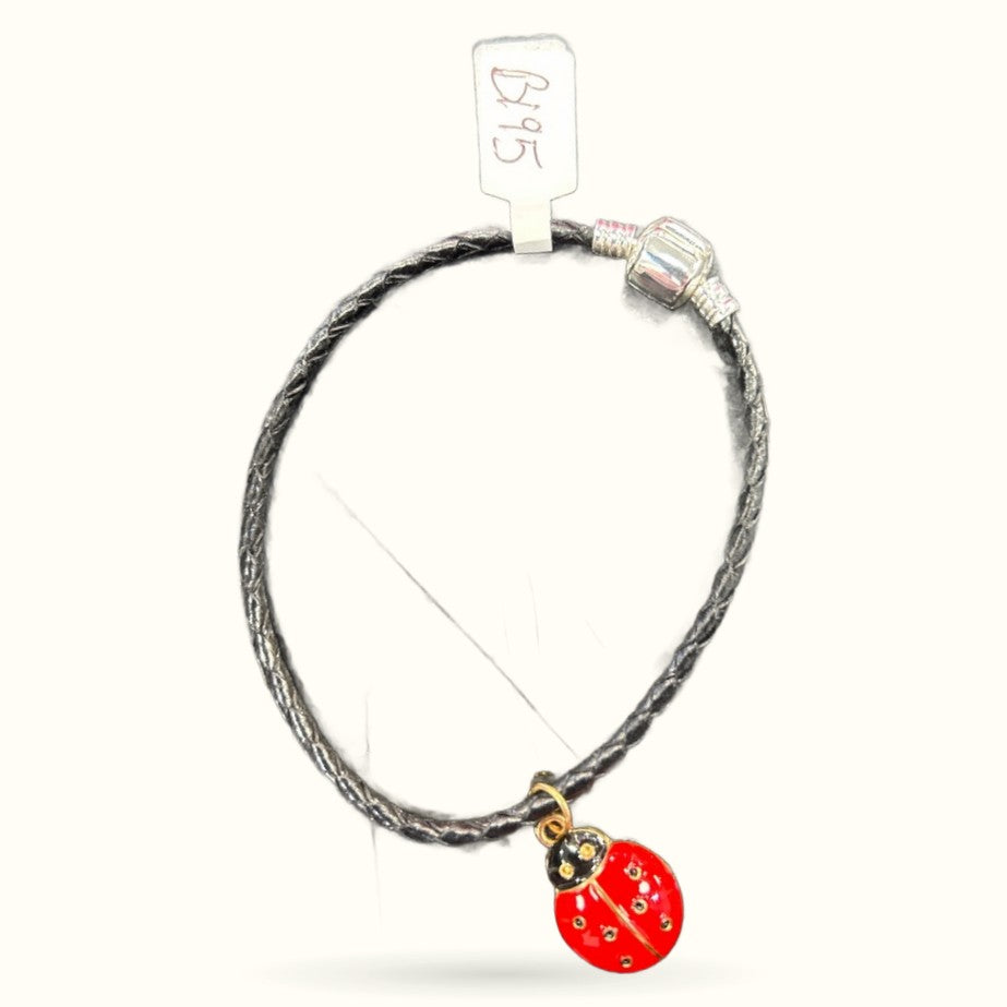 Black leather cord bracelet with red ladybug charm and crystal bead on price tag display