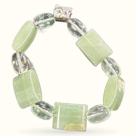 Chunky green aventurine bracelet with clear quartz beads and silver cat charm on white background