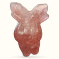 Strawberry quartz reindeer carving with pointed ears and polished finish against white background