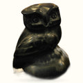 Polished black obsidian owl figurine with carved details, displayed against a white background