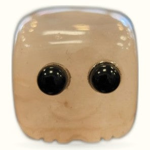 Rose quartz block buddy with black googly eyes and peaceful expression
