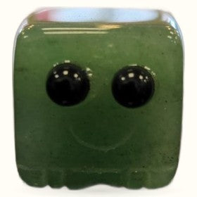 Green aventurine block buddy with two black tourmaline eyes and a smiling mouth