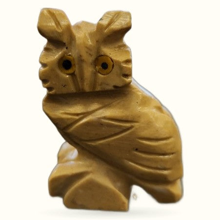 Golden-brown soapstone owl carving with detailed feather etching and dark stone eyes