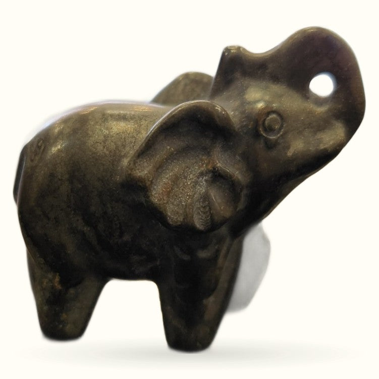 Dark bronze pyrite elephant figurine with raised trunk, small hole detail, viewed from side angle