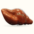 Polished red jasper carved into a sea shell shape with natural striations
