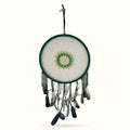 Large green woven dream catcher with white mesh center, green and yellow mandala design, and hanging feathers