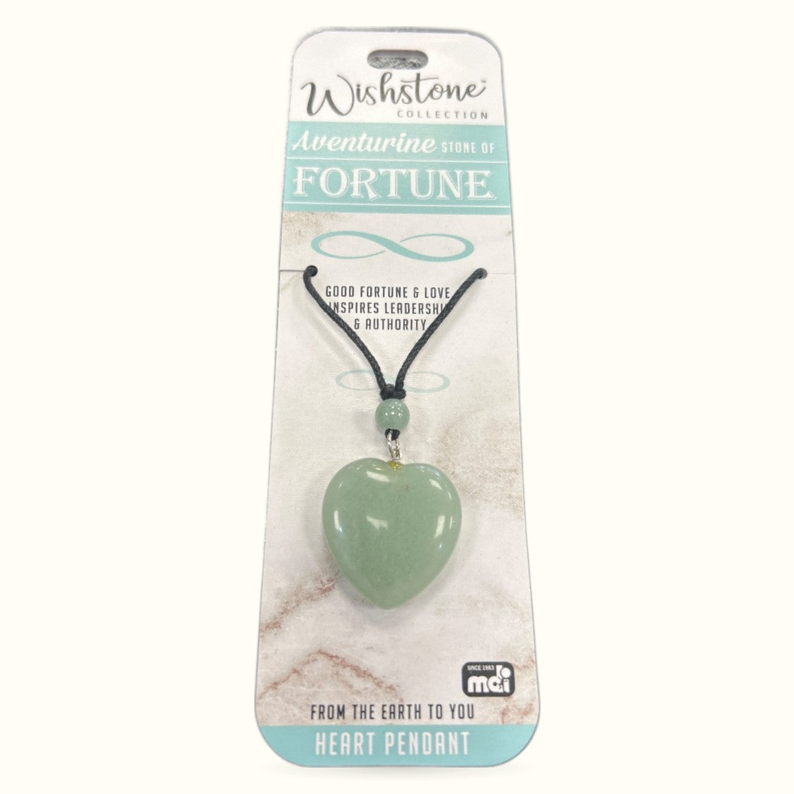 Green aventurine heart pendant on black cord with small bead detail, displayed on branded packaging