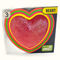 Smoosho Glow in the Dark Squishy Heart with red center and colorful rainbow layered borders