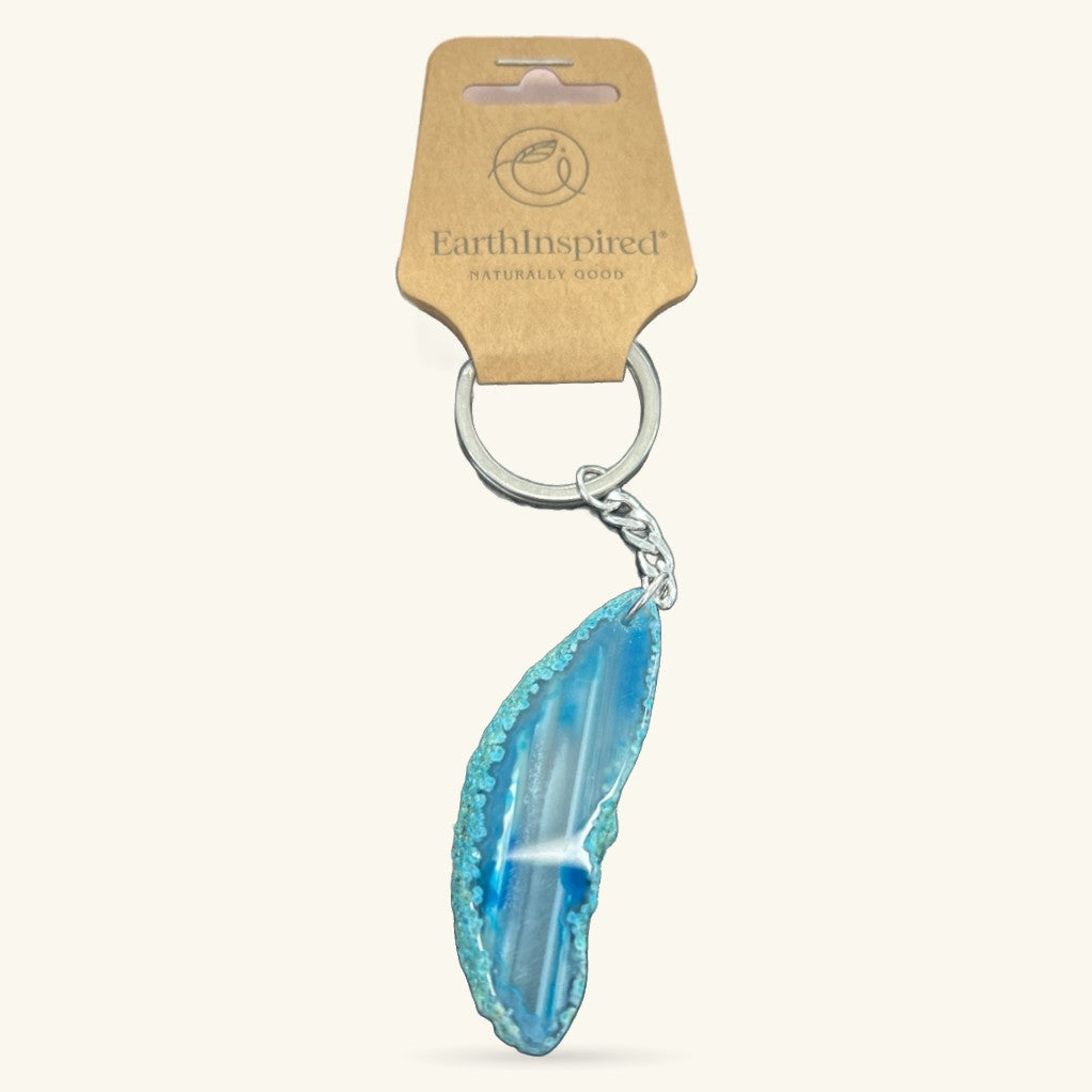 Blue agate slice keychain with silver ring and chain, attached to EarthInspired branded cardboard tag