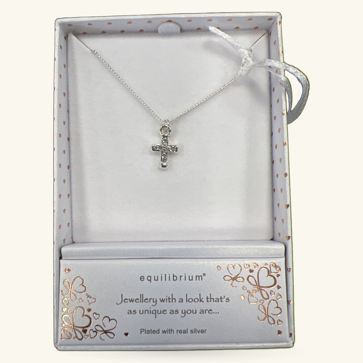 Silver cross pendant necklace in Equilibrium branded box with rose gold heart pattern