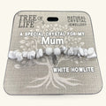 White Howlite chip bracelet with silver accent charm on branded Tree of Life packaging