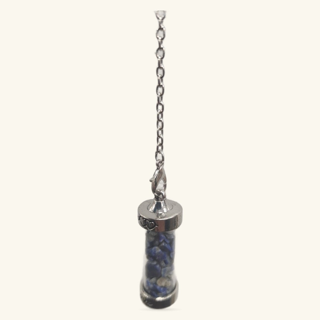 Silver-capped sodalite pendulum with blue stone interior, suspended from a delicate chain