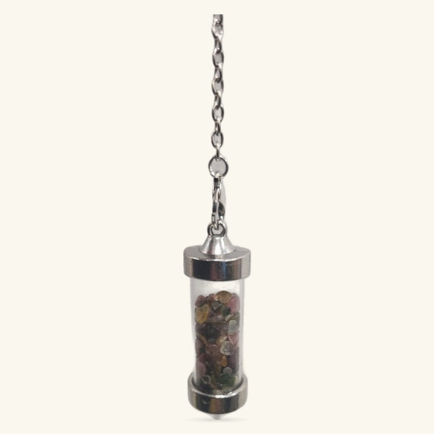 Silver-capped glass cylinder pendulum filled with mixed tumbled crystals, suspended from a chain