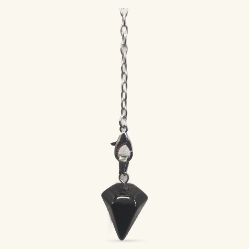Black obsidian point pendulum hanging from silver chain with lobster clasp against neutral background