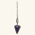 Mini amethyst point pendulum with silver chain and clasp on cream background