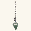Green aventurine pointed pendulum on silver chain with clasp against cream background