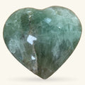Polished green fluorite heart stone, 7.5cm, featuring natural banding and faceted surfaces