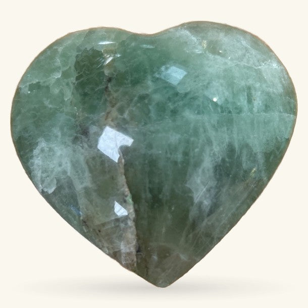 Polished green fluorite heart stone, 7.5cm, featuring natural banding and faceted surfaces