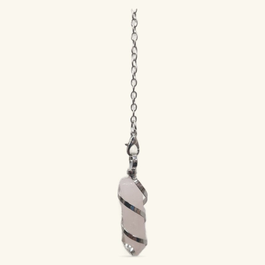 Rose quartz pendulum with spiraling metal wire wrap suspended from silver chain