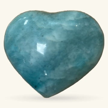 Polished aquamarine heart-shaped crystal with blue-green coloring and natural veining