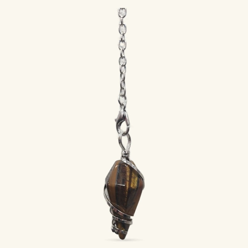 Tiger's Eye dowsing pendulum with brown banded stone in silver wire wrap, hanging from chain