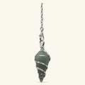 Green aventurine dowsing pendulum with silver wire wrapping on chain against cream background