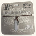Clear quartz point pendant on brown cord with Tree of Life charm, displayed on Health & Energy branded card