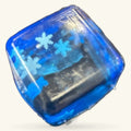Translucent blue square squishy toy with snowflake design and dark interior gel filling