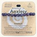 Purple amethyst bead bracelet with 10 polished stones on cardboard packaging labeled 'Amethyst for Anxiety'